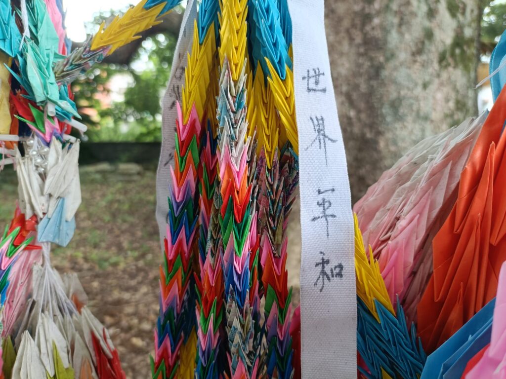 What Happens in Nagasaki on August 9: Inside the Moment of Silence at Sannō Shrine Paper cranes tied near the shrine bearing the words "World Peace"