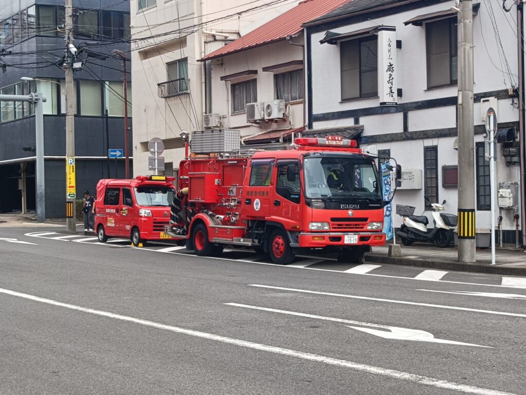 One Night a Year, Firecrackers Take Over the Streets: Nagasaki's Shoro Nagashi A fire truck standing by at a street corner before Shoro Nagashi begins
