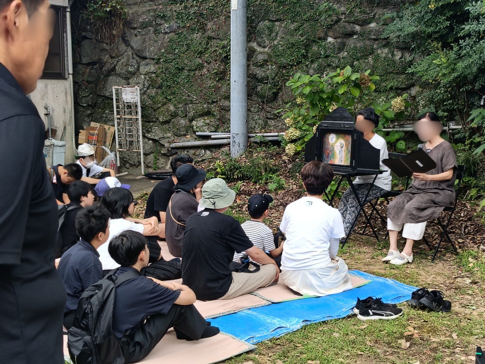 What Happens in Nagasaki on August 9: Inside the Moment of Silence at Sannō Shrine Kamishibai storytellers perform a peace-themed picture story for children at Sannō Shrine, faces blurred for privacy